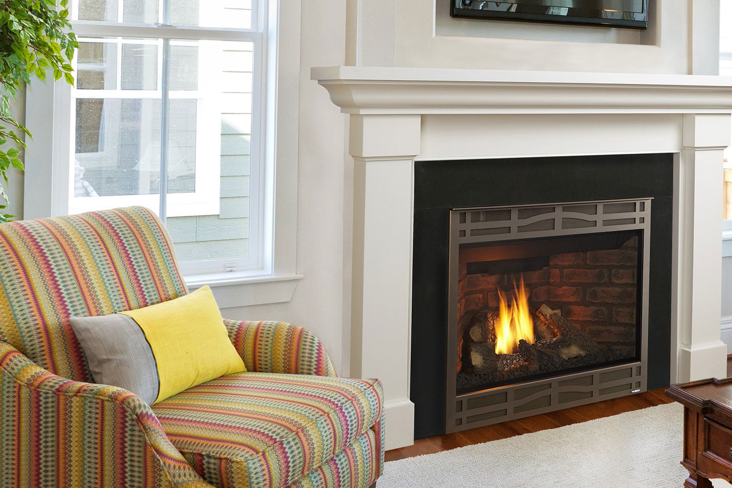 Novus gas fireplace with in living room with colorful chair