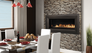 A lit ventless gas fireplace with stone surrounding, in a living area.