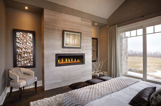 Primary bedroom with modern gas fireplace