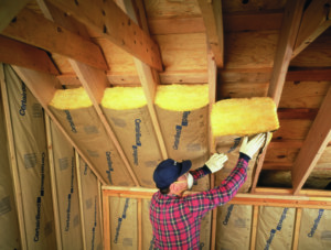 Certainteed fiberglass batt insulation being installed in attic.
