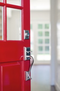red front door with steel colored door handle and deadbolt