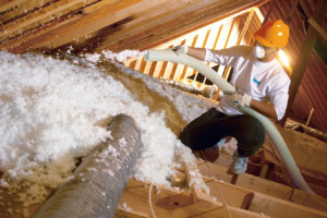 Knauf fiberglass blown insulation being blown into attic.
