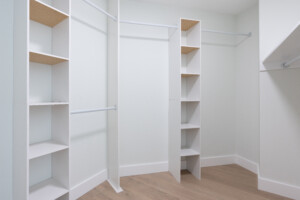 primary walk in closet with built in shelving